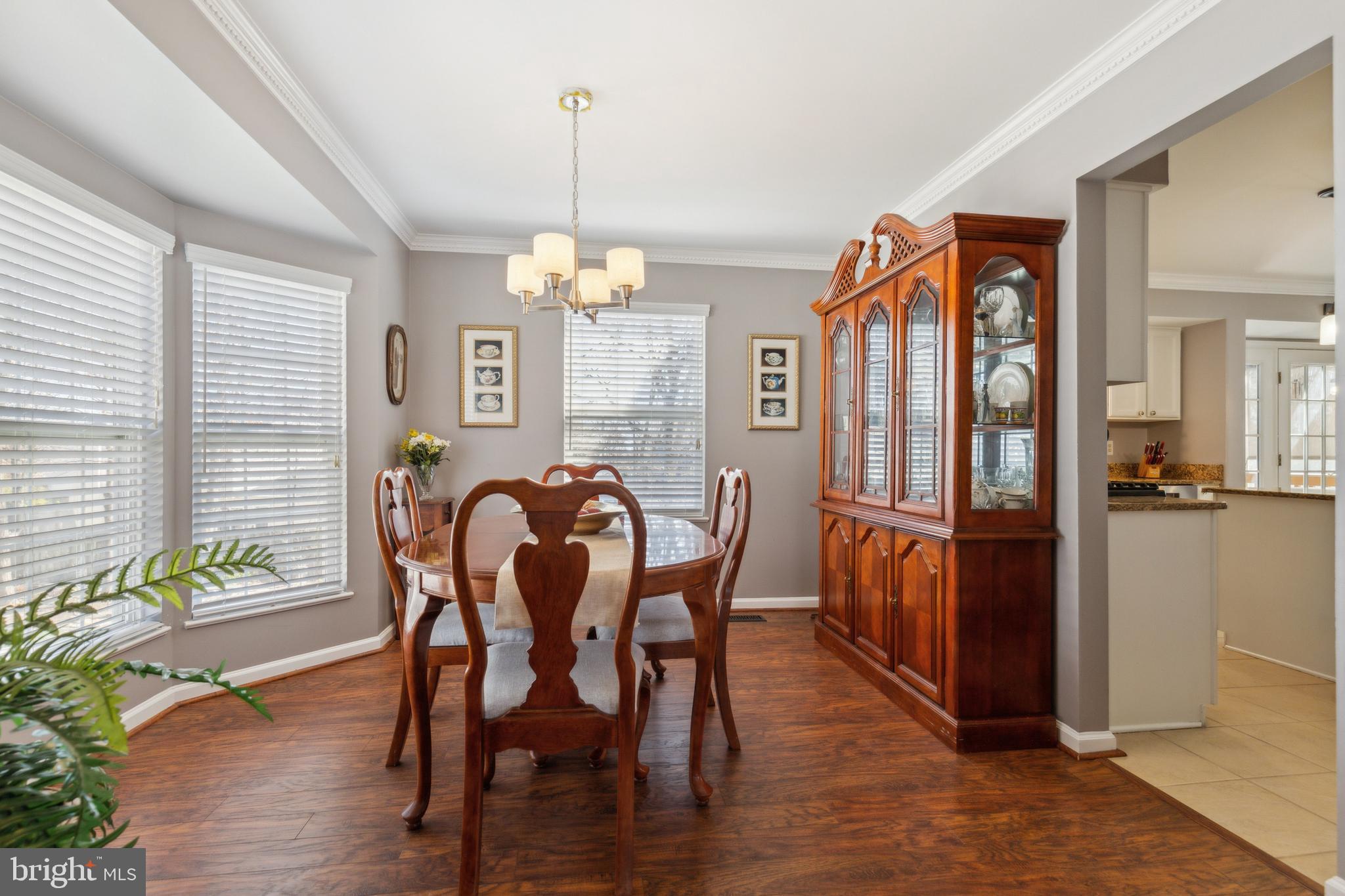 20752 Cross Timber Drive Ashburn, VA 20147 - Photo 10 of 39 a view of a dining room with furniture window and wooden floor