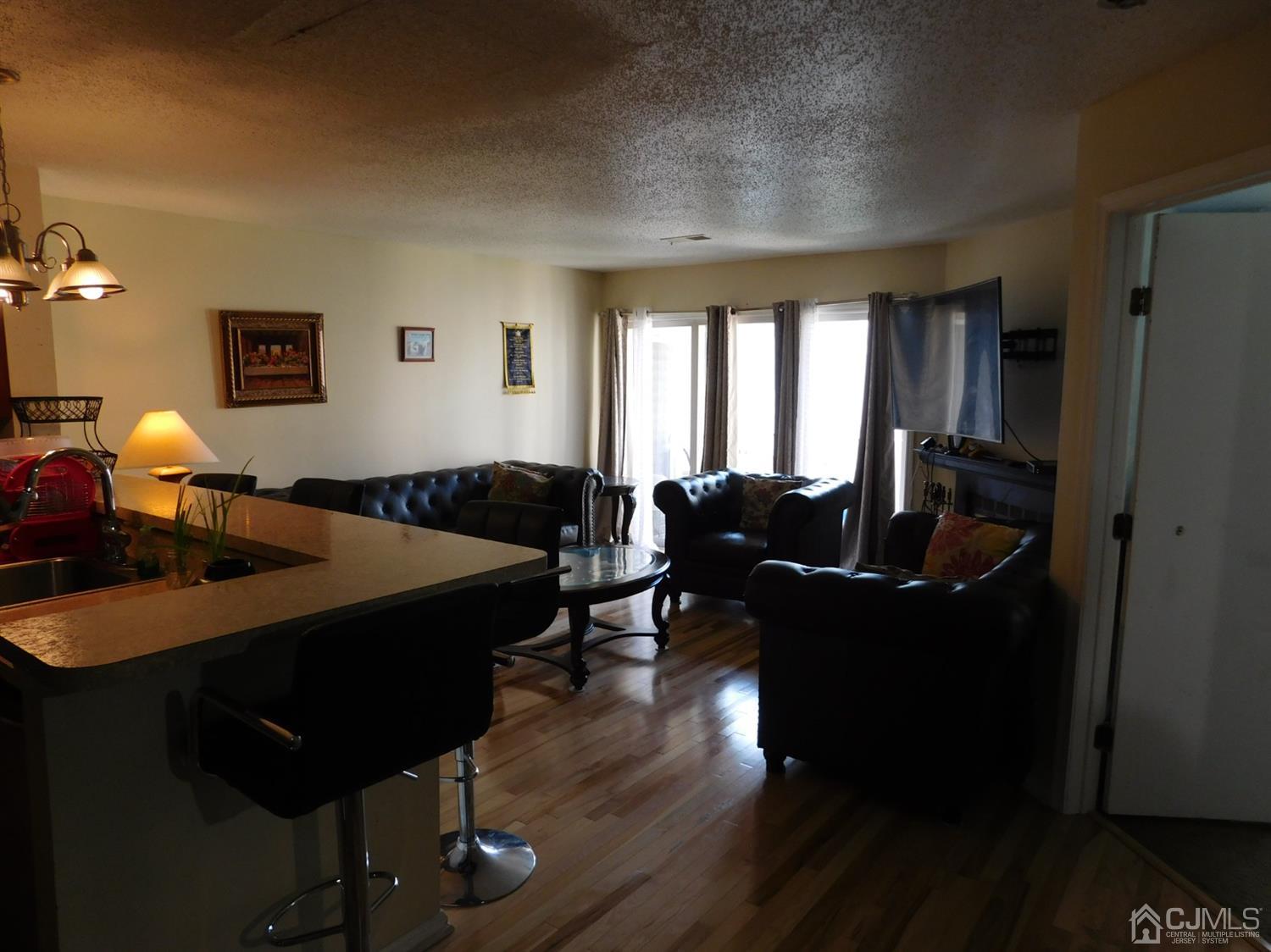 723 Edpas Road New Brunswick, NJ 08901 - Photo 2 of 20 a living room with furniture a window and a lamp