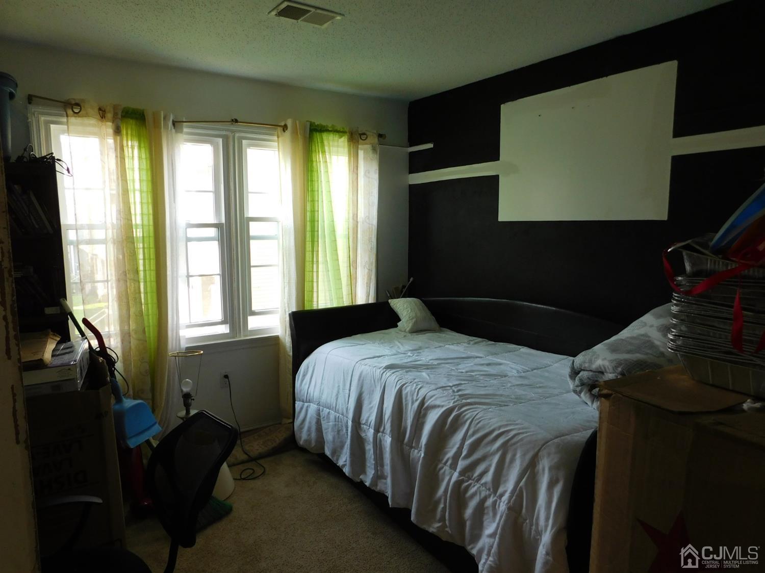723 Edpas Road New Brunswick, NJ 08901 - Photo 11 of 20 a bedroom with a bed next to a window