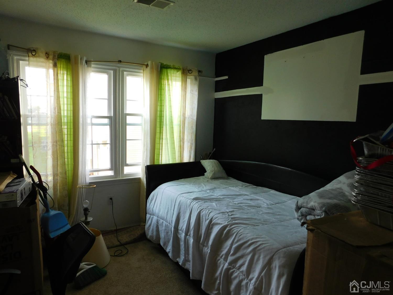 723 Edpas Road New Brunswick, NJ 08901 - Photo 12 of 20 a bedroom with a bed next to a window