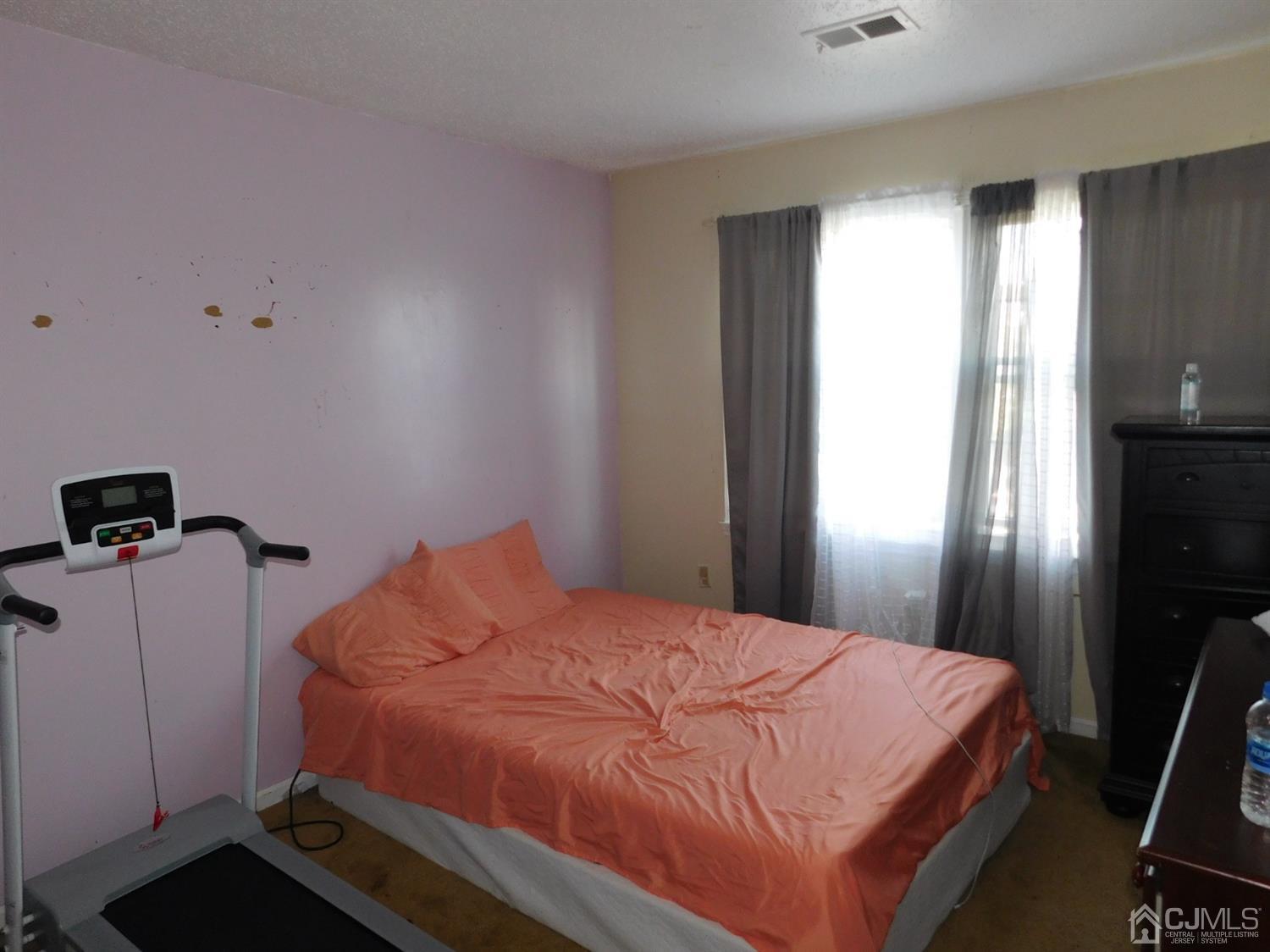 723 Edpas Road New Brunswick, NJ 08901 - Photo 15 of 20 a bedroom with a bed and a window