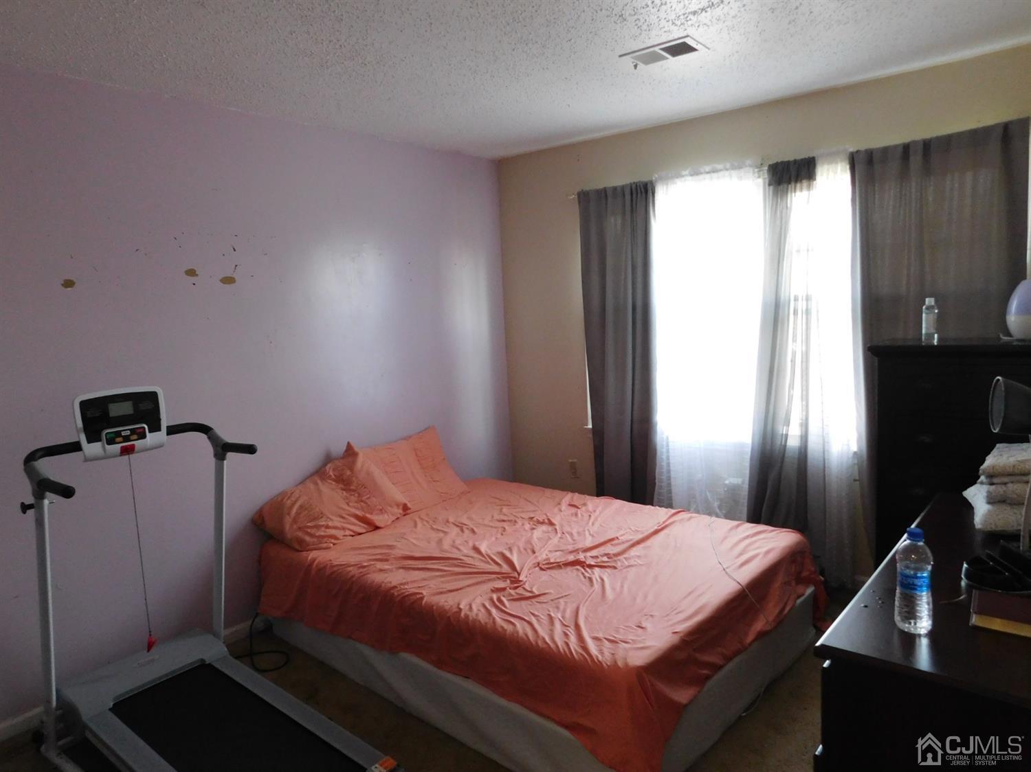 723 Edpas Road New Brunswick, NJ 08901 - Photo 16 of 20 a bedroom with a bed and wooden floor