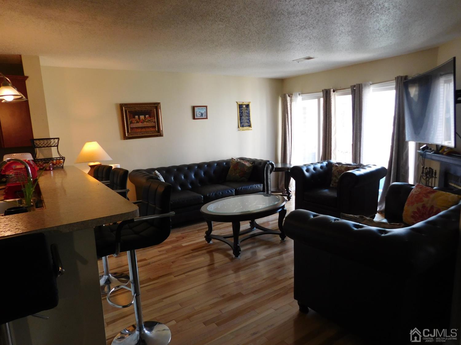 723 Edpas Road New Brunswick, NJ 08901 - Photo 3 of 20 a living room with furniture a desk and chair with wooden floor