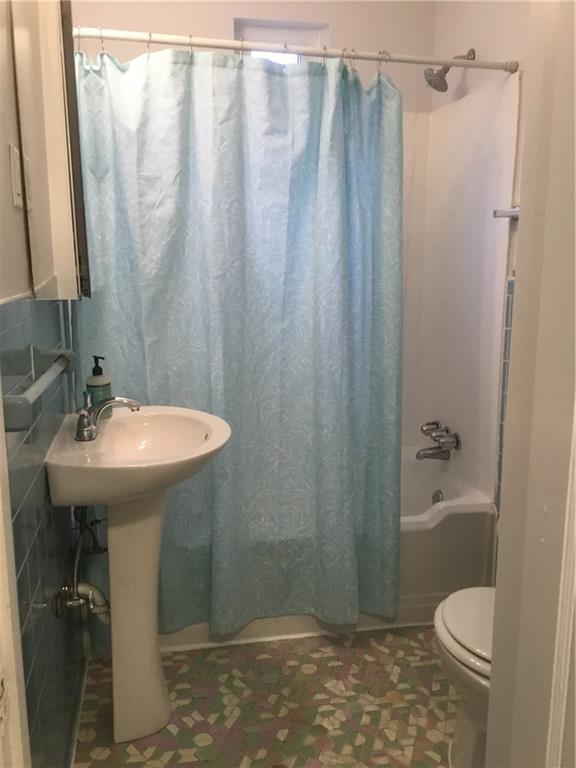 5450 Covode Place Pittsburgh, PA 15217 - Photo 15 of 25 a bathroom with a sink a toilet and shower curtain