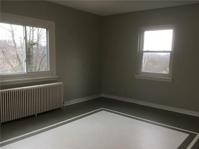 an empty room with wooden floor