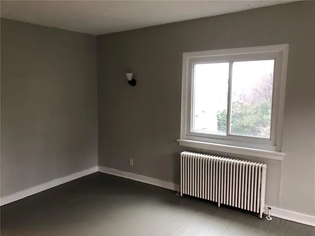 an empty room with windows and closet