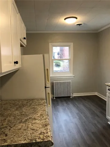 a view of a kitchen from a hallway
