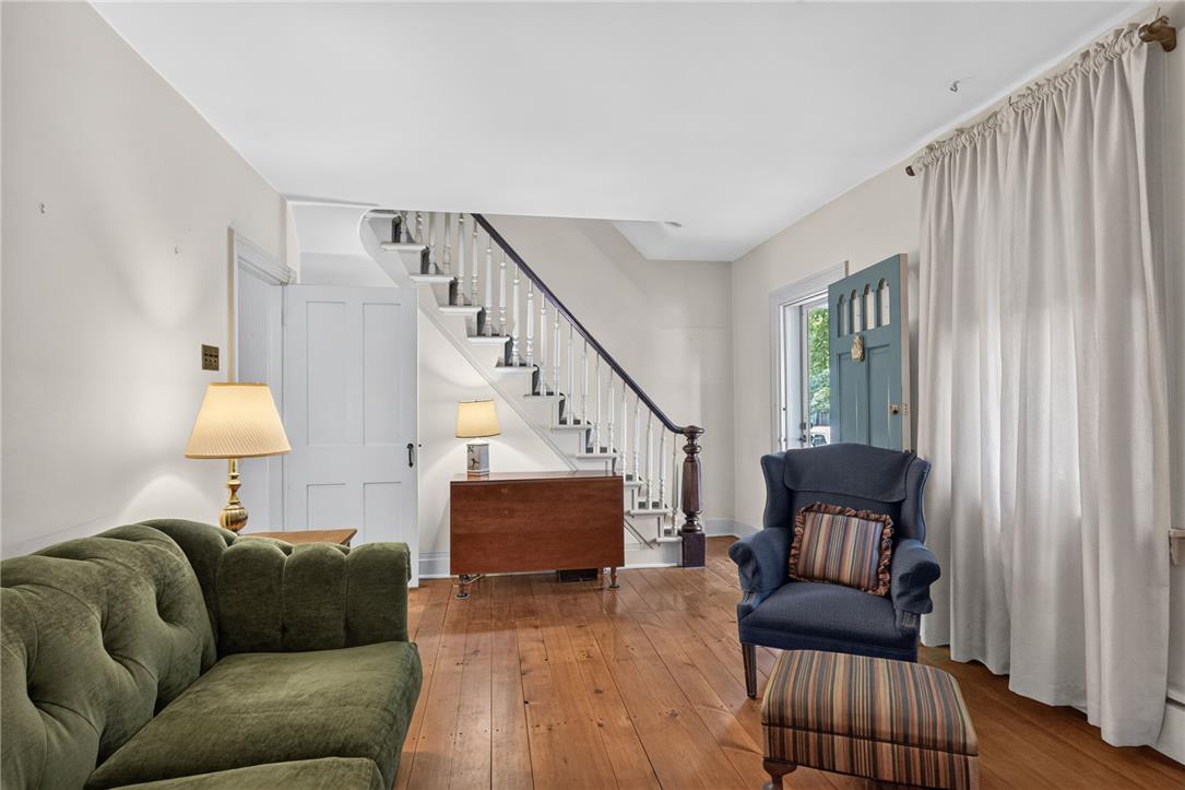 765 East Macada Road Bethlehem, PA 18017 - Photo 11 of 46 Hearty wood floors guide you through this inviting living space, connecting seamlessly to a classic staircase.