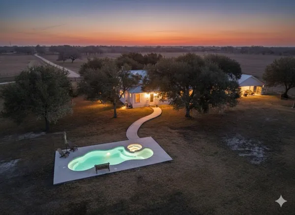 an aerial view of a house with a yard swimming pool and mountain view