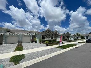 14531 Bretton Woods Trace Delray Beach, FL 33446 - Photo 17 of 57 a view of a street with a building in the background