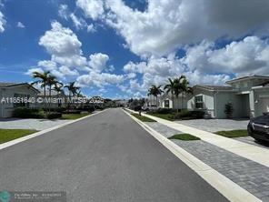 14531 Bretton Woods Trace Delray Beach, FL 33446 - Photo 2 of 57 a front view of a house with a yard and garage