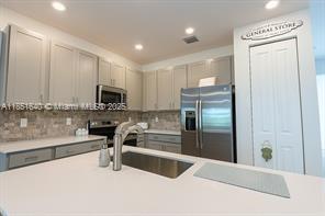 14531 Bretton Woods Trace Delray Beach, FL 33446 - Photo 4 of 57 a kitchen with a refrigerator and a sink
