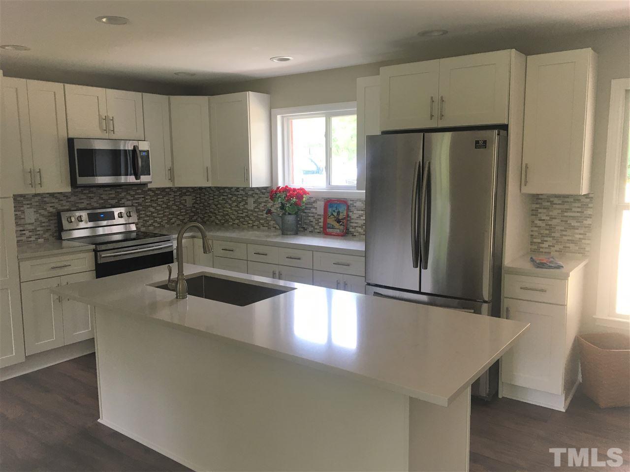 932 Bluestone Road Durham, NC 27713 - Photo 3 of 18 Light and bright kitchen with brand new Samsung Refrigerator, Stove, Microwave. New cabinets and island. Lots of storage and counter space!