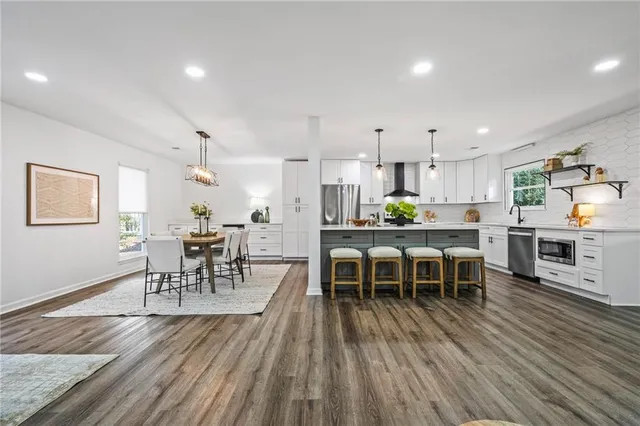 a dining room with furniture wooden floor and a rug