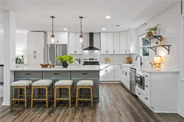 a kitchen with cabinets a sink a counter space and stainless steel appliances
