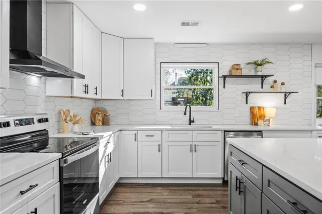 a kitchen with a sink stove and cabinets