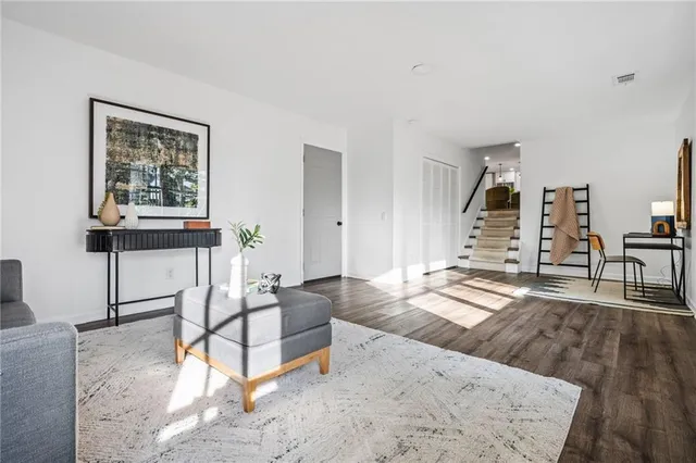 a living room with furniture and wooden floor