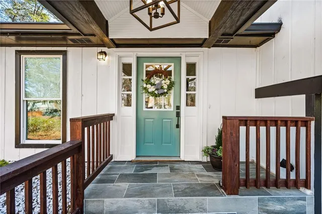 a view of a porch with wooden floor and a potted plant