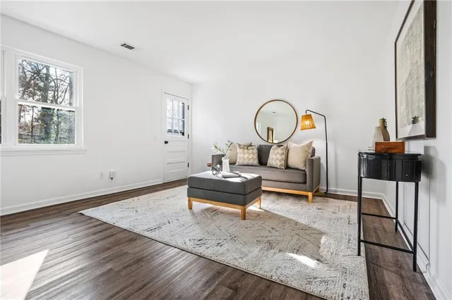 a living room with furniture a rug and a large window