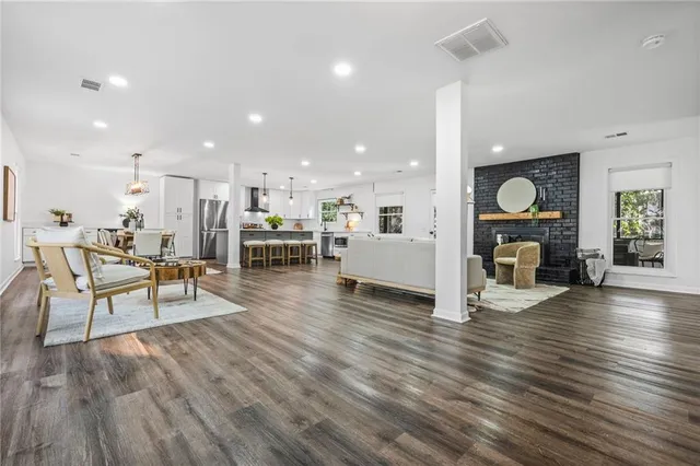 a living room with furniture and wooden floor