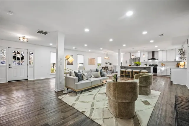 a living room with furniture and kitchen view