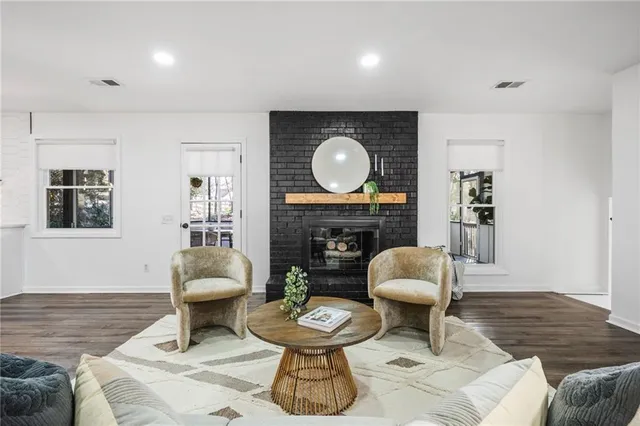 a living room with furniture a window and a fireplace