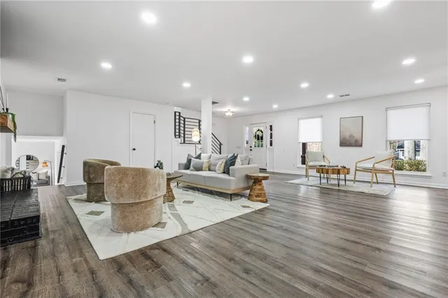 a living room with furniture and a wooden floor