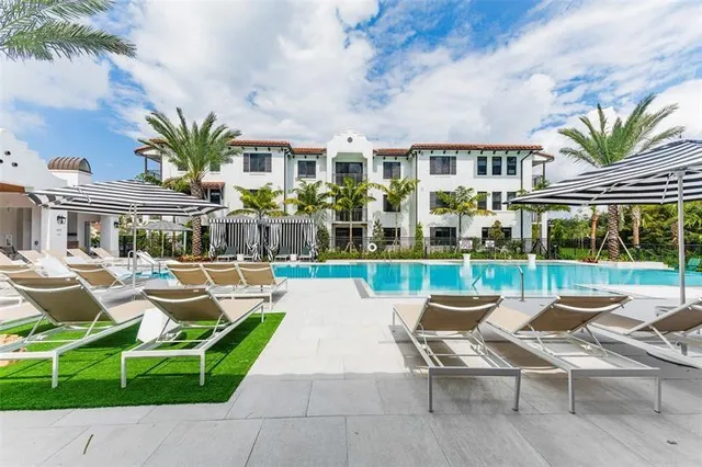 a patio with sofas table and chairs