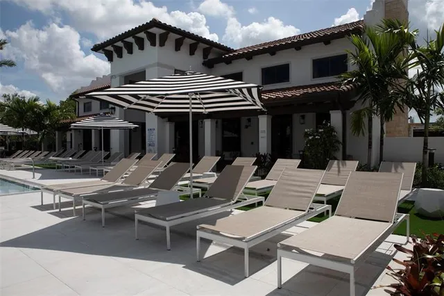a view of a patio with couches table and chairs and potted plants