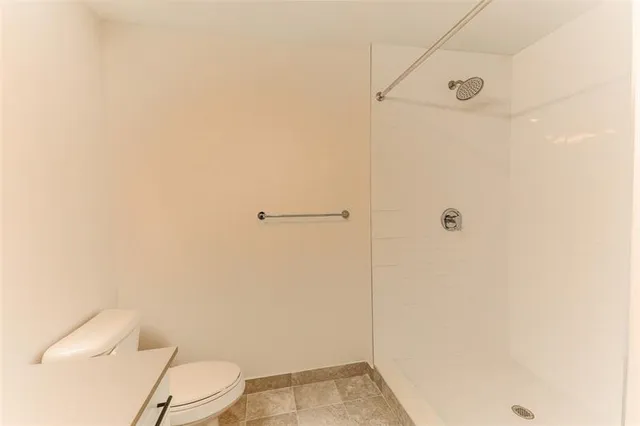 a bathroom with a toilet and shower