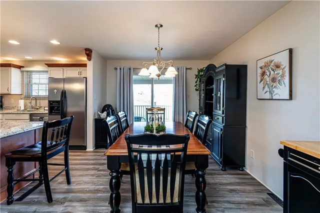 a dining room with furniture and wooden floor