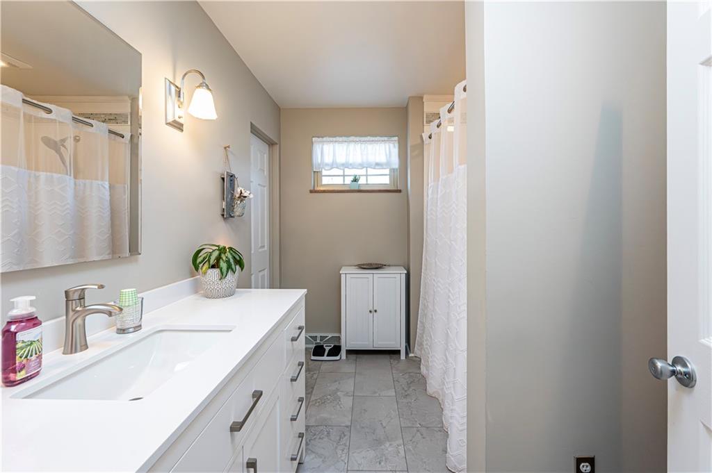108 Stewart Road Derry, PA 15627 - Photo 18 of 30 a bathroom with a granite countertop sink mirror and vanity