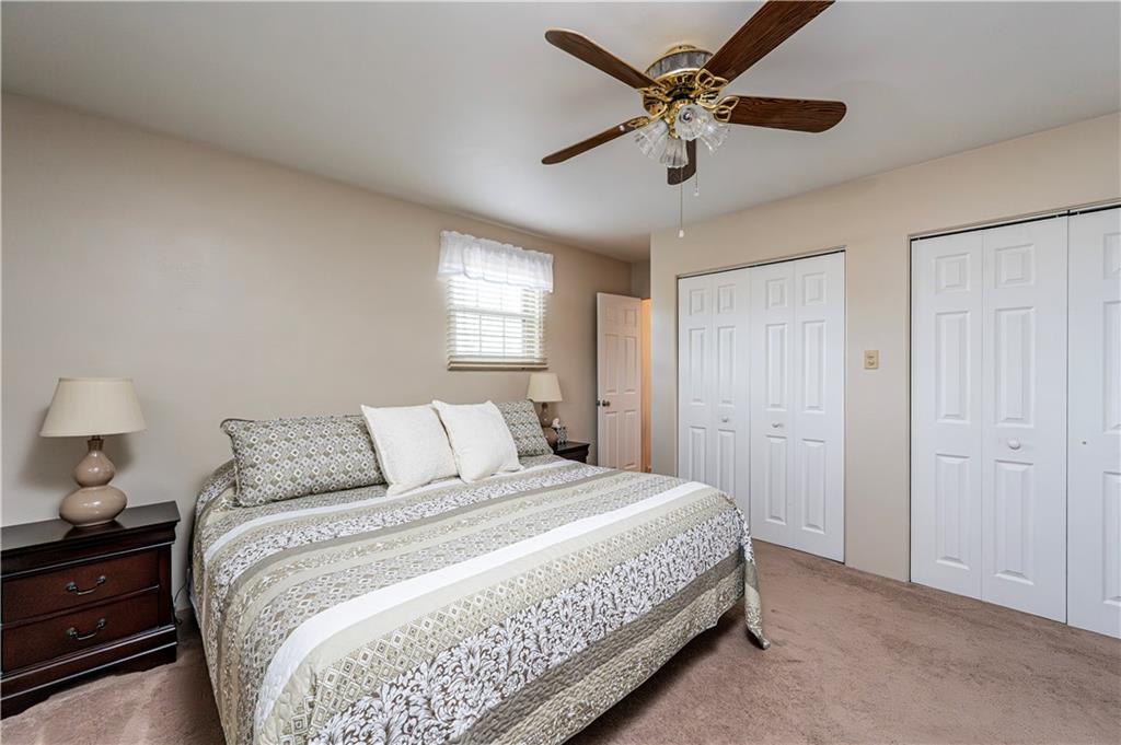 108 Stewart Road Derry, PA 15627 - Photo 19 of 30 a bedroom with a bed and a chandelier