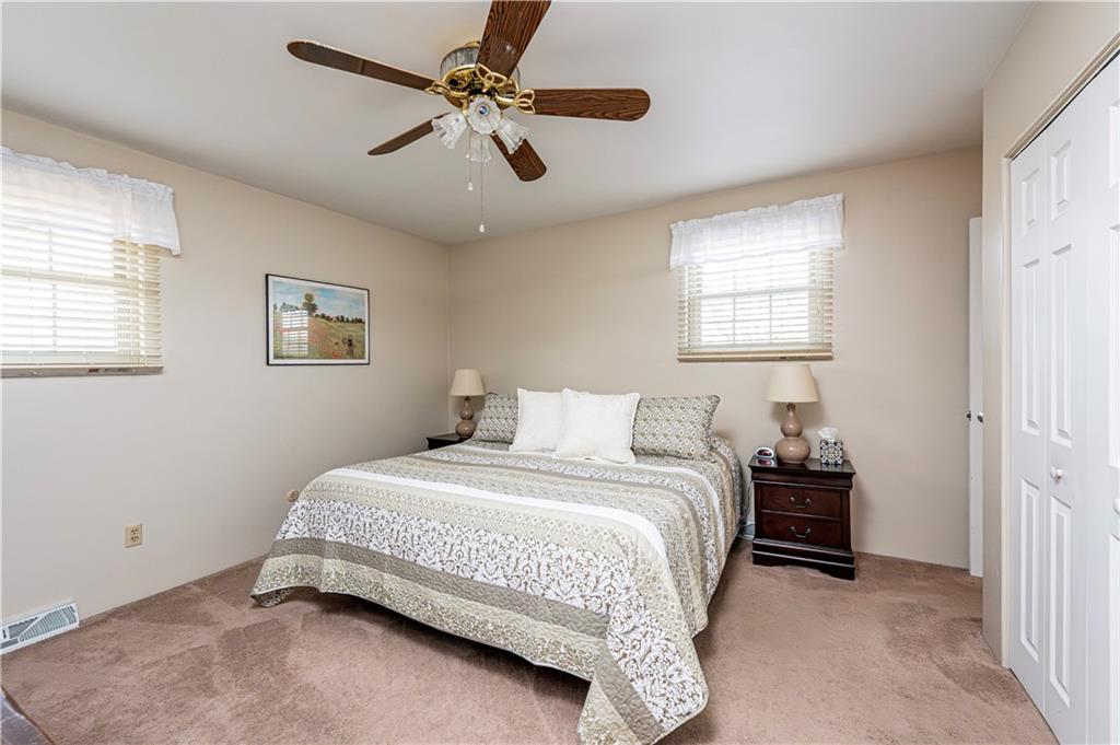 108 Stewart Road Derry, PA 15627 - Photo 20 of 30 a bedroom with a bed and a chandelier