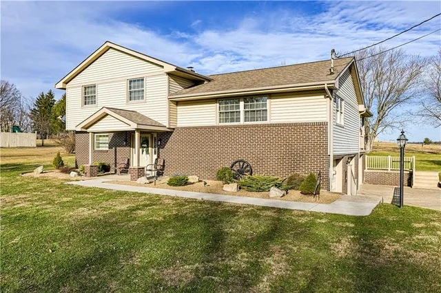 a front view of a house with a garden and yard