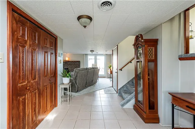 a view of a hallway to dining room and chandelier