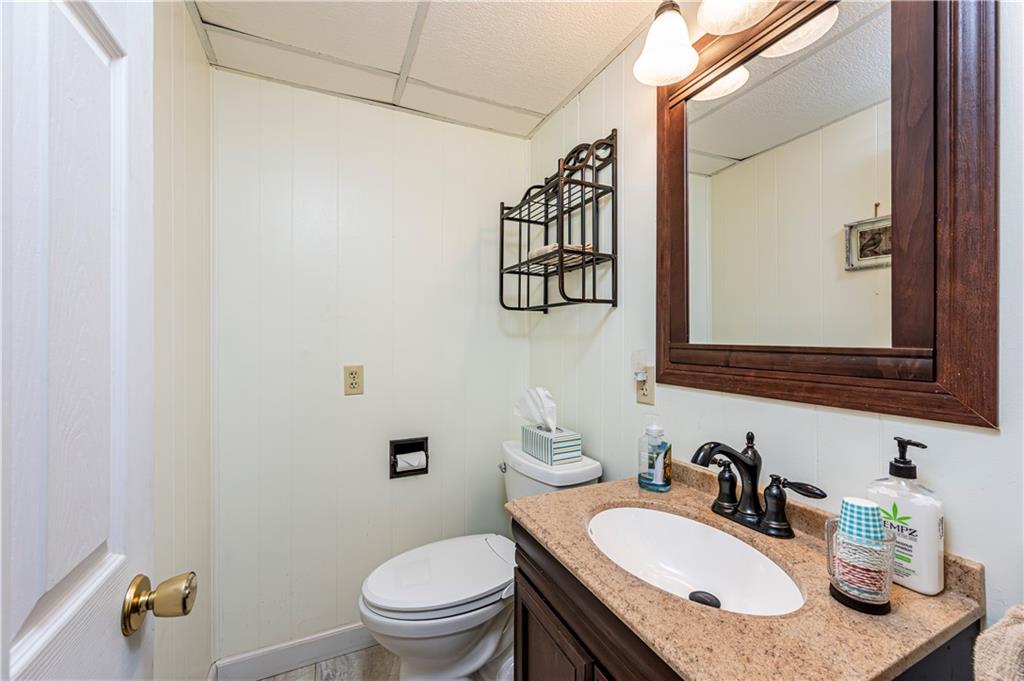 108 Stewart Road Derry, PA 15627 - Photo 10 of 30 a bathroom with a granite countertop sink vanity mirror and toilet