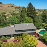 an aerial view of a house with yard and outdoor seating