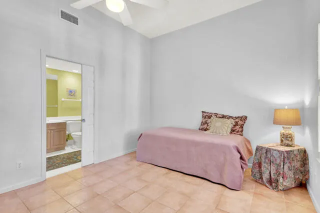 a living room with lots of furniture a rug kitchen view and a large window