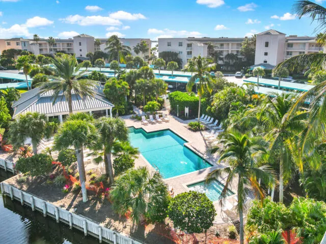 a backyard of a house with table and chairs plants