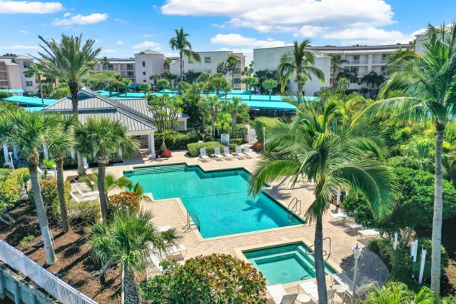 an aerial view of residential houses with outdoor space and lake view