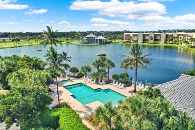 a view of a city with lots of residential buildings ocean and mountain view in back
