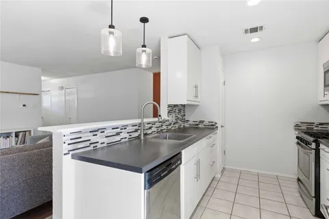 a kitchen with a sink and a stove top oven