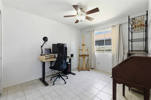 a view of a workspace with furniture and a window