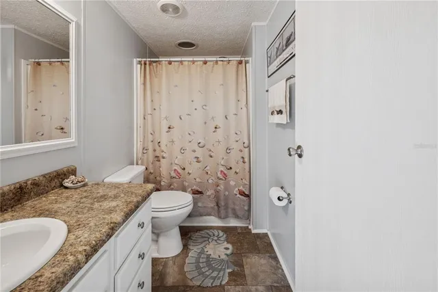 a view of a house with backyard and a tree