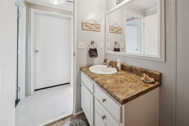 a view of backyard with wooden fence and large trees