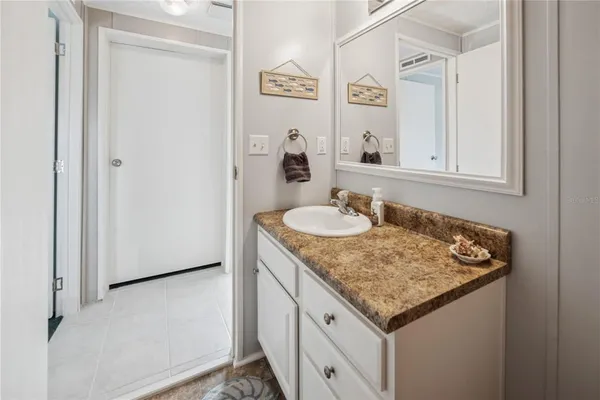 a spacious bedroom with a bed and wooden floor