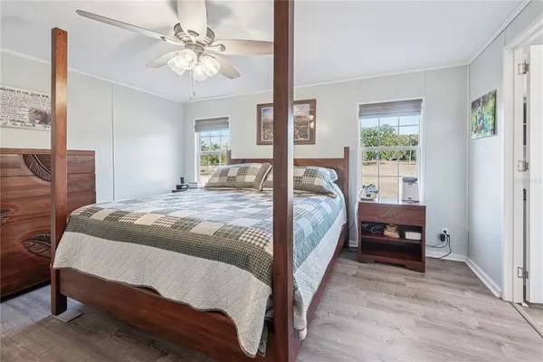 a bed room with a bed and wooden floor
