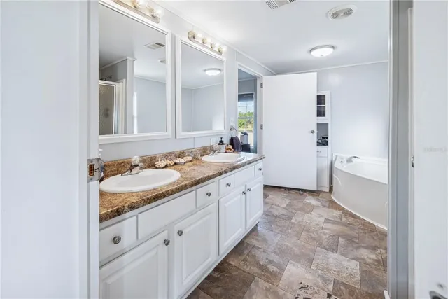 a view of a kitchen with wooden floor and a refrigerator