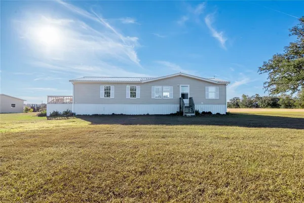 a view of a chair and tables in the back yard